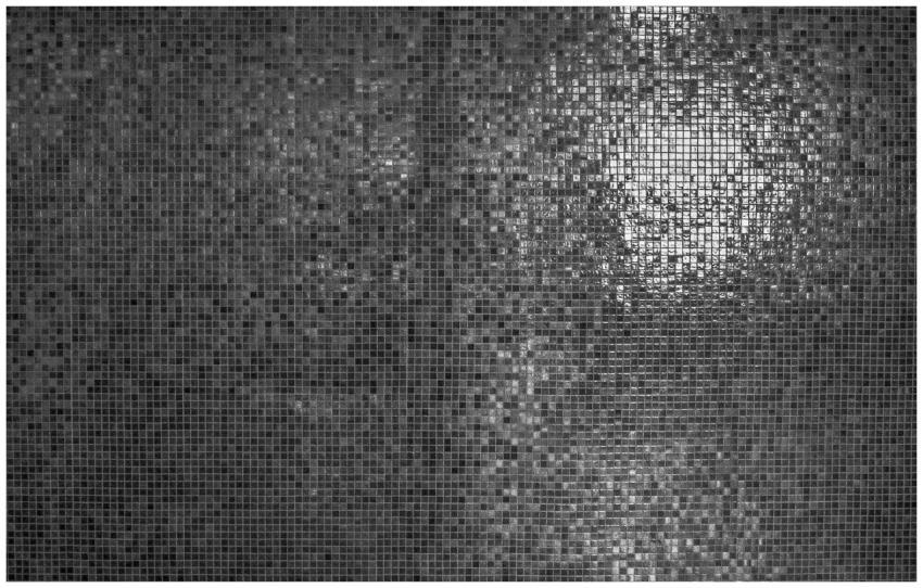 A detailed grayscale mosaic texture with reflectiv