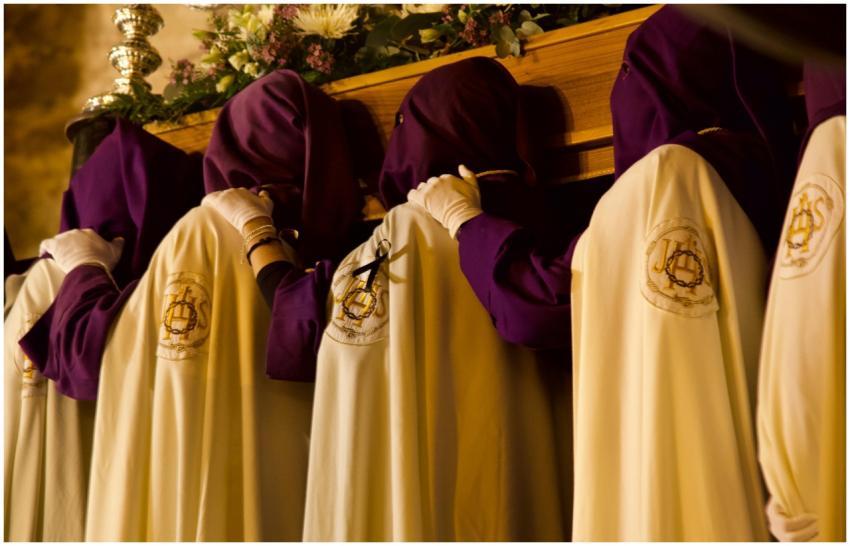 Hooded figures in a Semana Santa procession in Tru