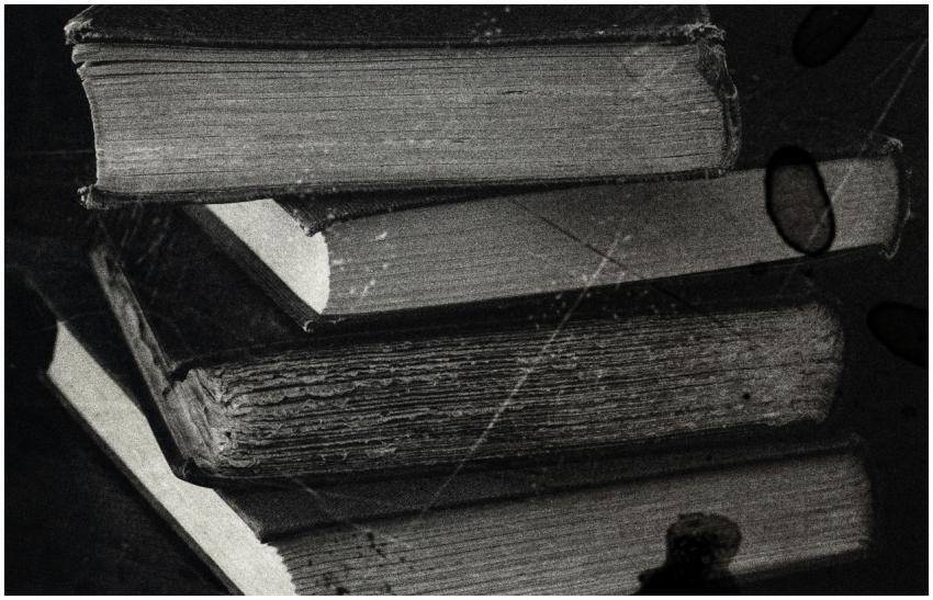 Close-up of a stack of vintage books in black and