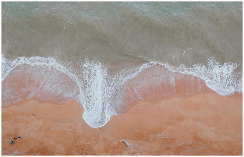 Captivating aerial view of ocean waves gently wash