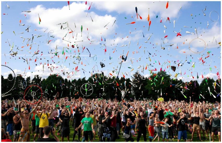 A lively crowd enjoying a colorful juggling event