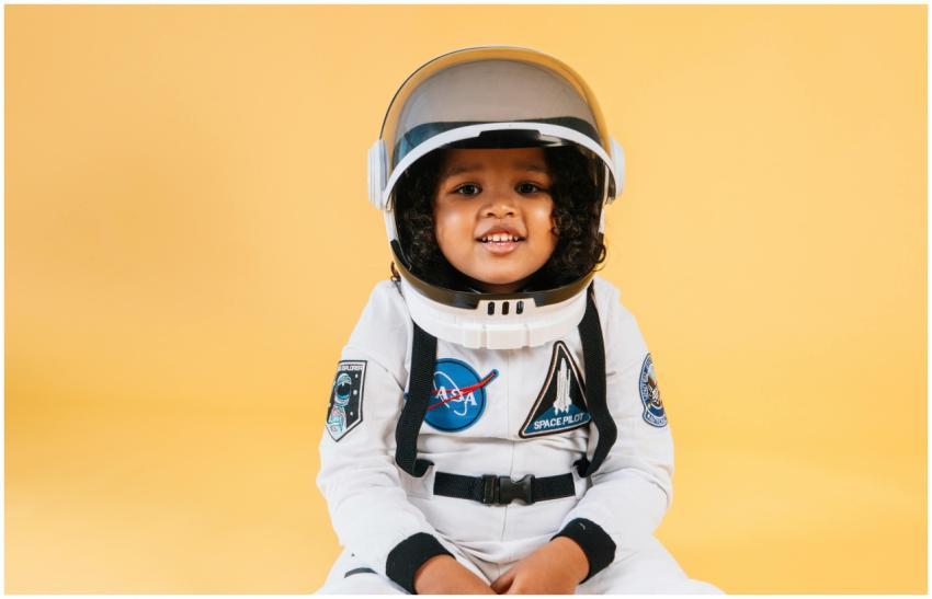 Cute child wearing an astronaut suit and helmet sm