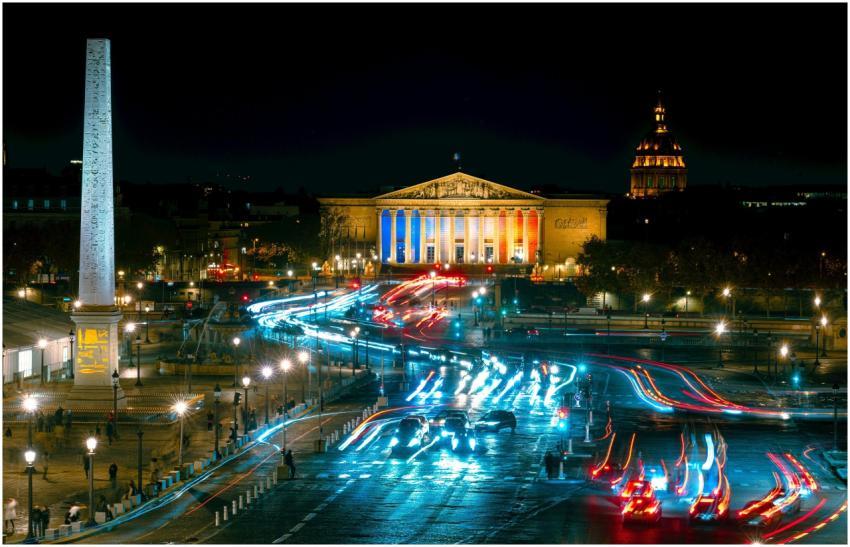 Vibrant night view of Paris traffic and iconic lan