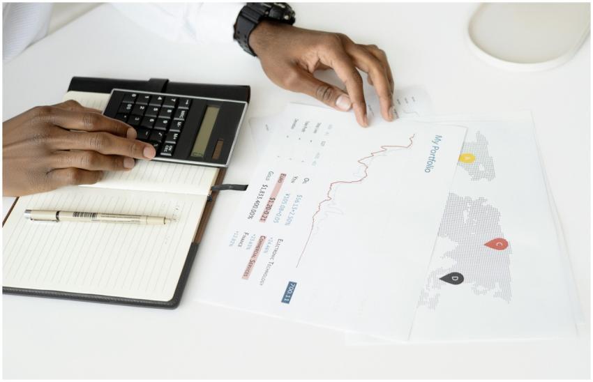 Overhead view of a person analyzing financial docu