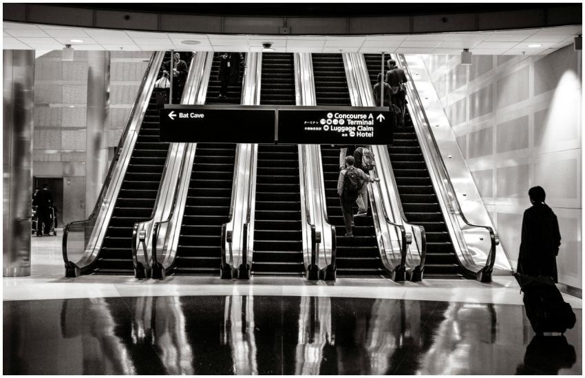 Travelers on escalators in a modern airport termin