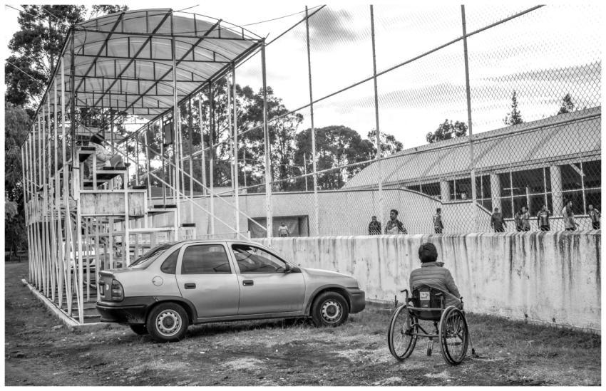 A person in a wheelchair watches a sports event in