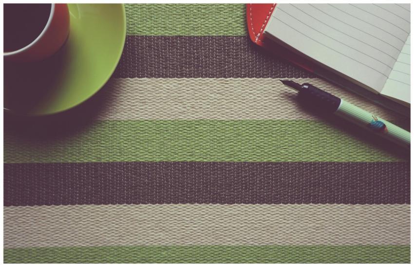 A stylish workspace setup featuring a coffee cup,