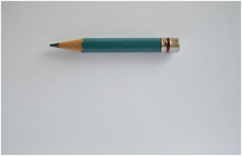 Minimalist image of a sharpened green pencil on a