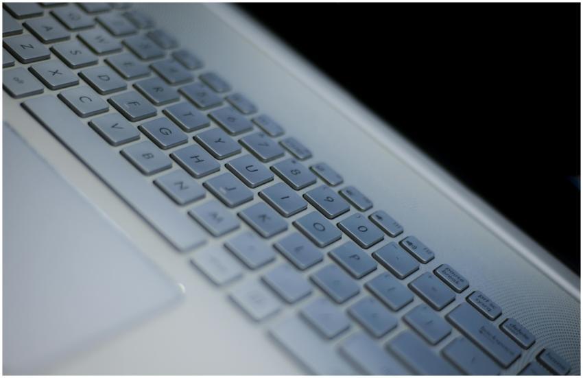 Detailed view of a white laptop keyboard with ambi