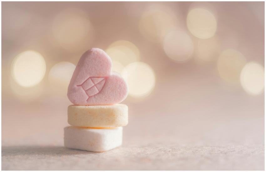 Close-up of heart-shaped candy with a warm bokeh b