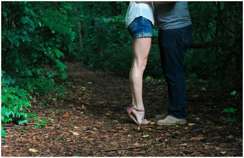 A loving couple embracing on a secluded forest pat