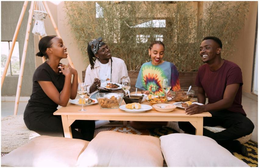 Four friends sharing a joyful meal together outdoo