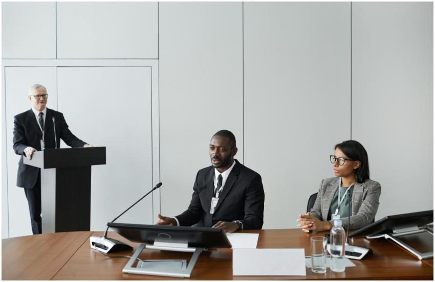 Colleagues in corporate attire discussing at a bus