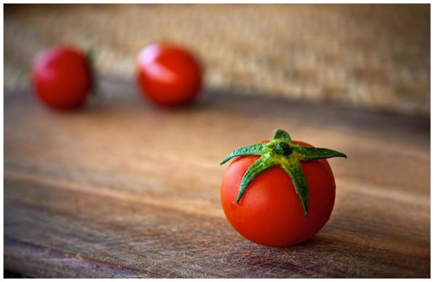 Vibrant cherry tomatoes resting on a rustic wooden