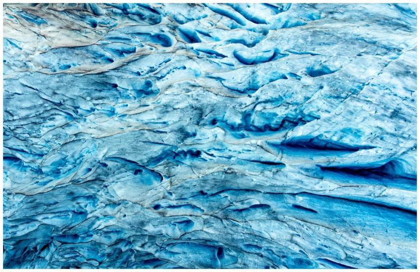 A detailed close-up of vivid blue glacier ice text