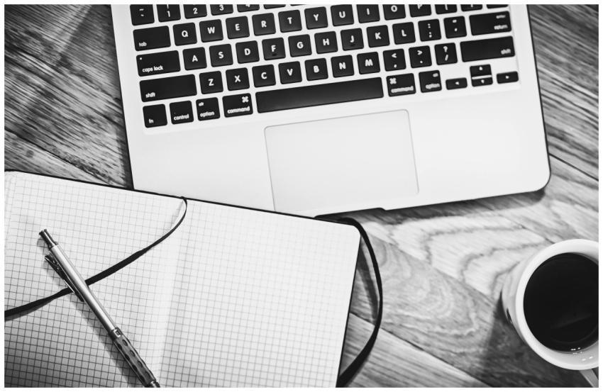 Black and white image of a workspace featuring a l