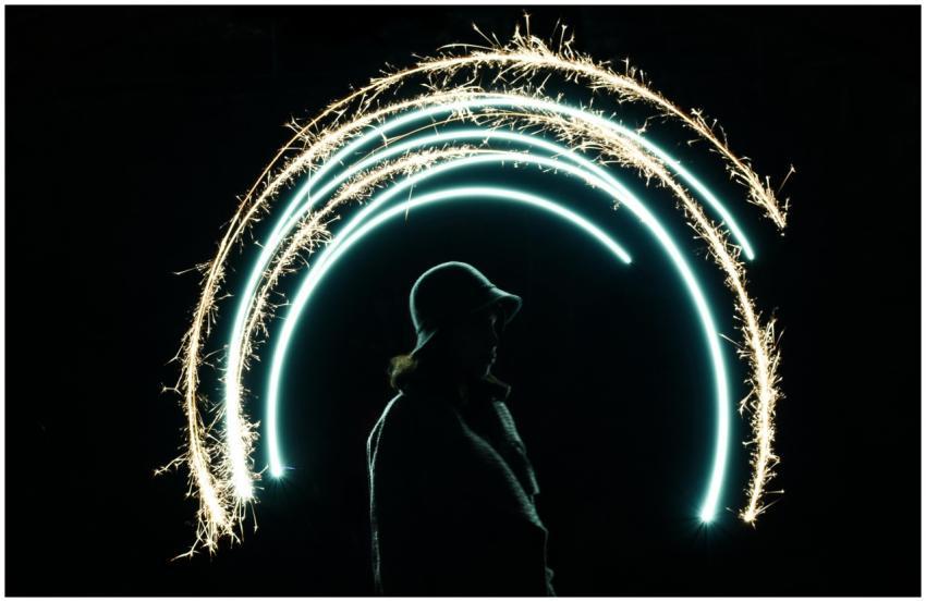 Silhouette of a person with hat illuminated by spa