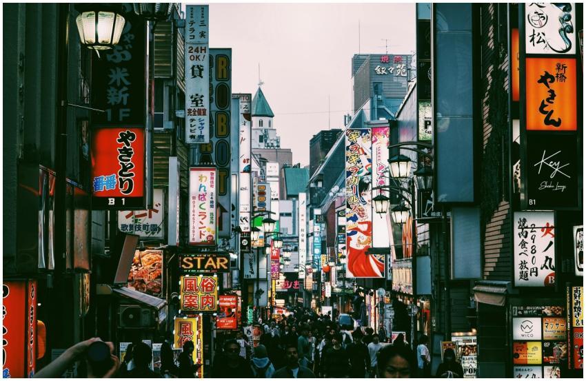 Bustling Tokyo shopping street filled with signs a