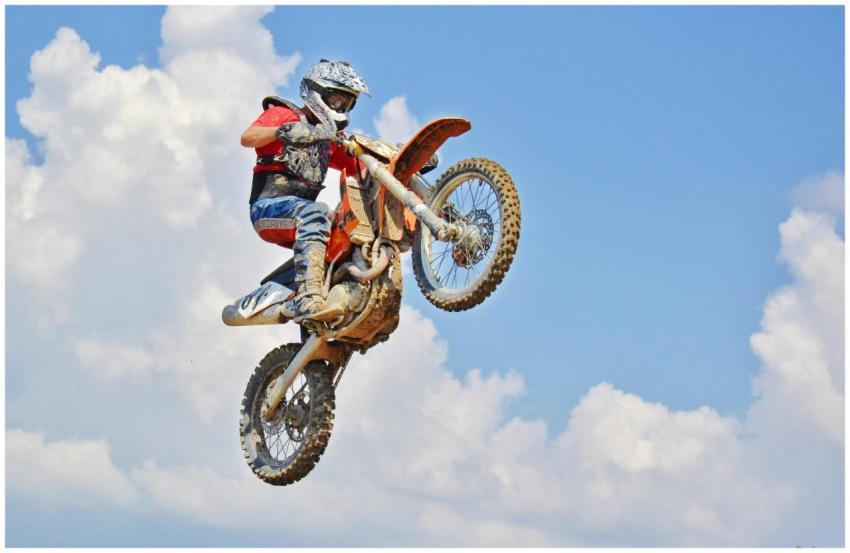 Motocross rider performs an airborne jump under a
