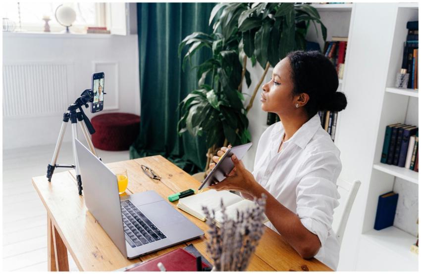 Black woman using electronic devices for vlogging