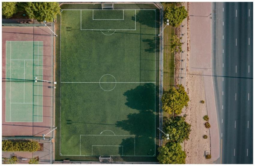 An aerial shot of a football and tennis court in D