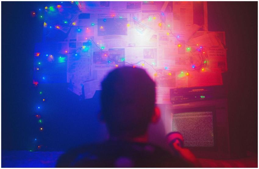 A dark room illuminated by colorful string lights