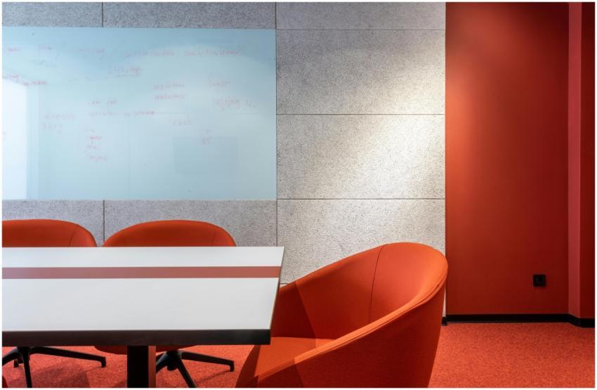 Stylish contemporary conference room with red chai