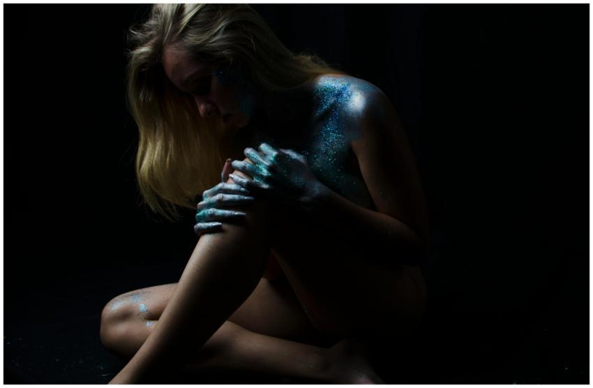 Artistic nude portrait featuring body paint with g