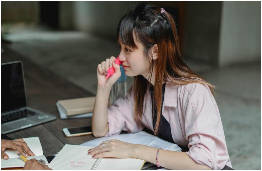 Asian woman focused on studying with laptop and no