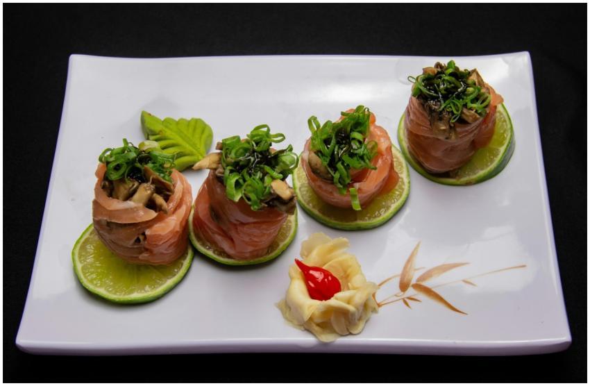 Elegant salmon sushi rolls garnished with greens o
