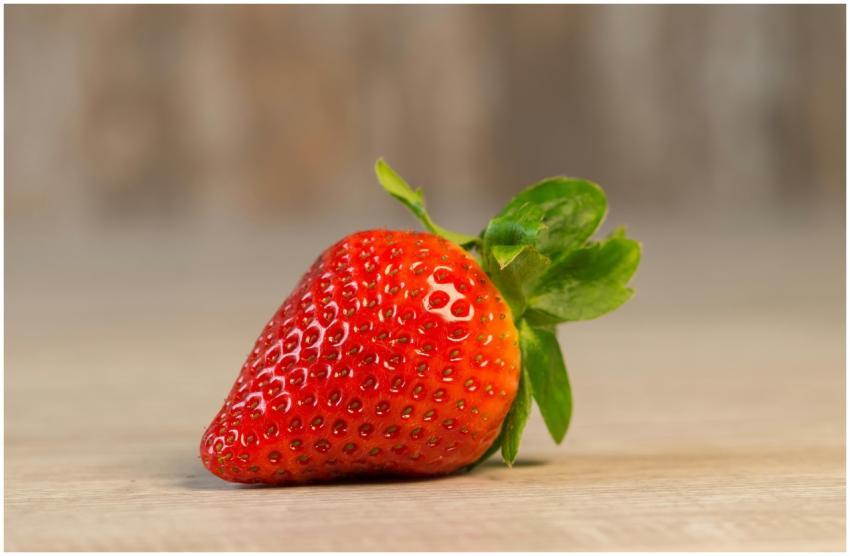 A vibrant close-up of a single, ripe strawberry sh