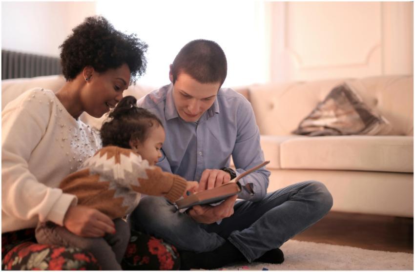 A diverse family enjoying storytime together, fost