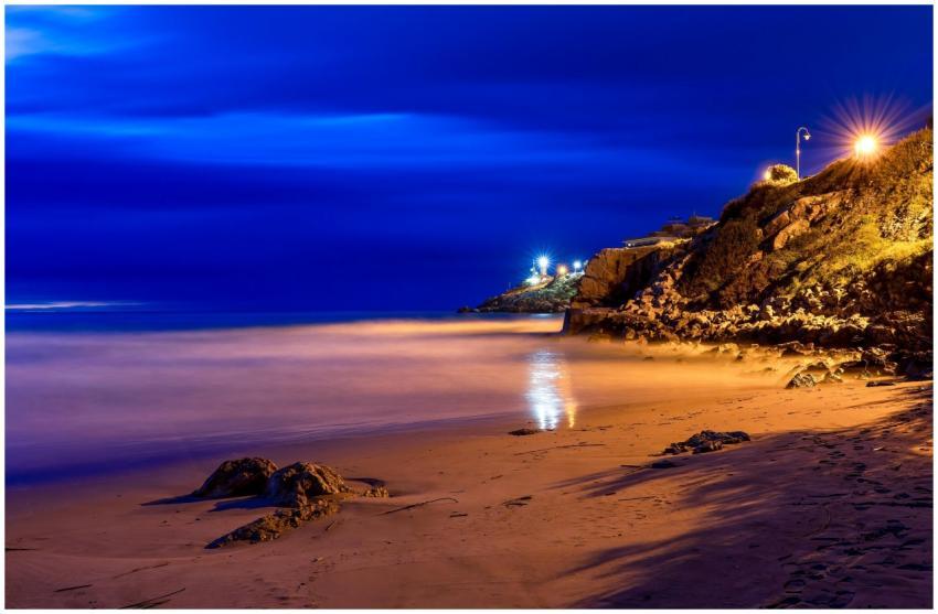 Quiet nighttime scene of Cullera beach with illumi