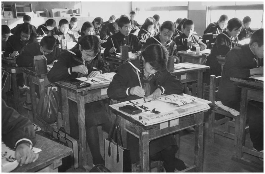 East Asian students writing calligraphy in a Japan