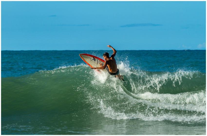 A surfer skillfully riding a wave with a surfboard