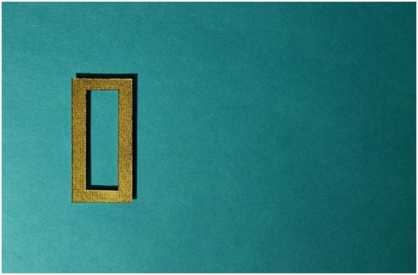 A gold rectangular frame casting a shadow on a tea