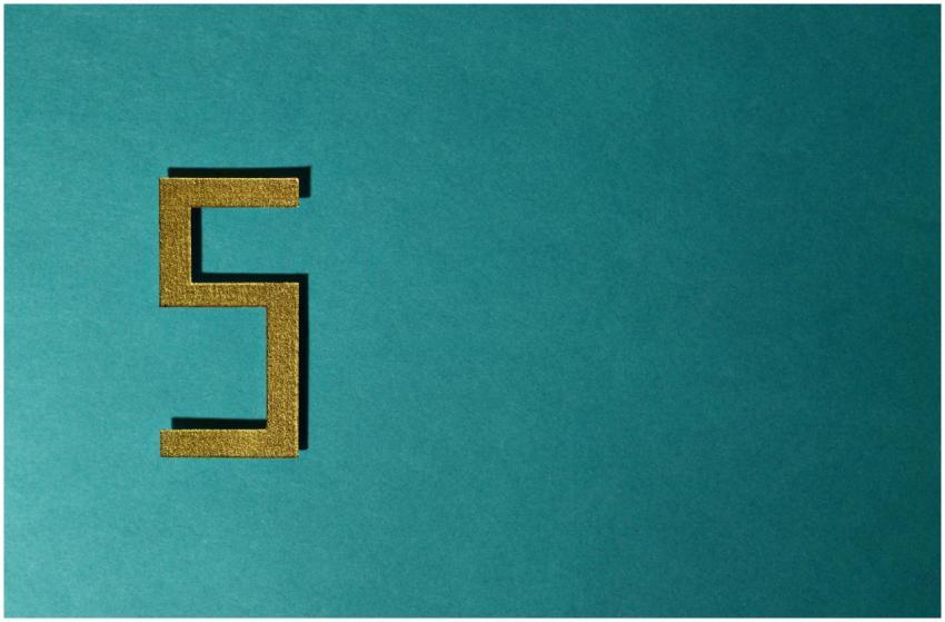 Abstract photo featuring a golden number five on a