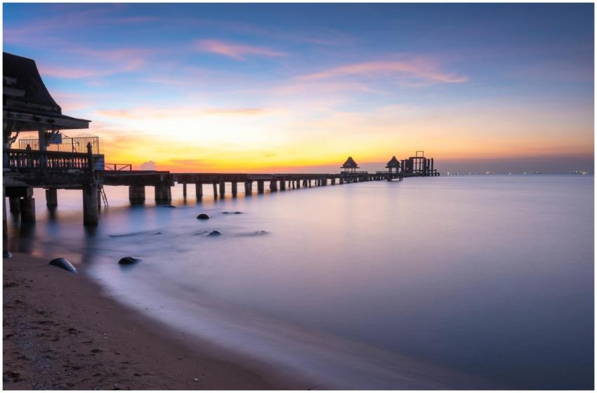 Tranquil sunset view of a pier extending into the
