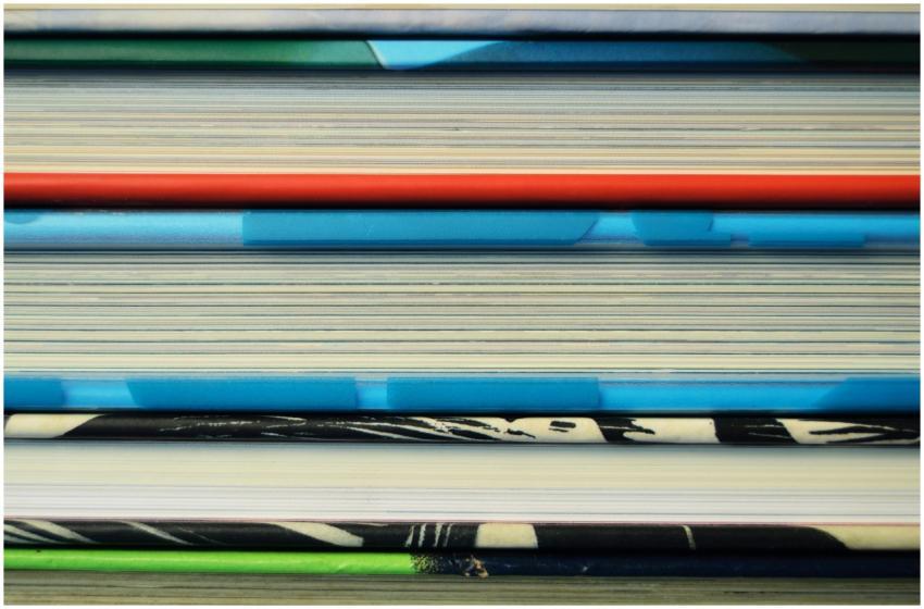 Close-up image of colorful hardcover books stacked
