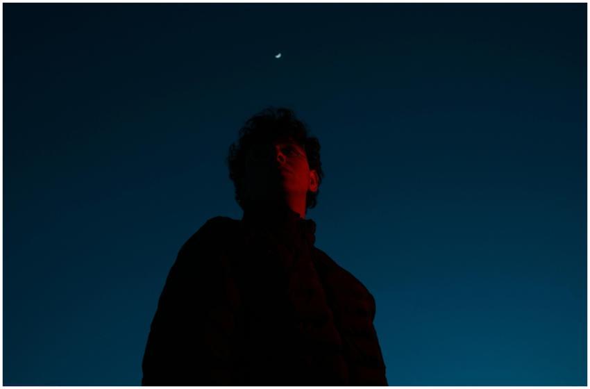 Dramatic low-angle photo of a man silhouetted agai