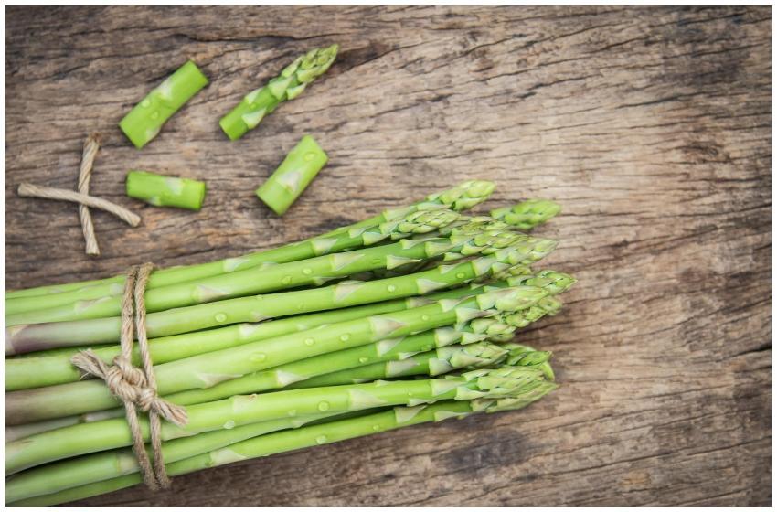 Bundle of fresh organic asparagus on a rustic wood