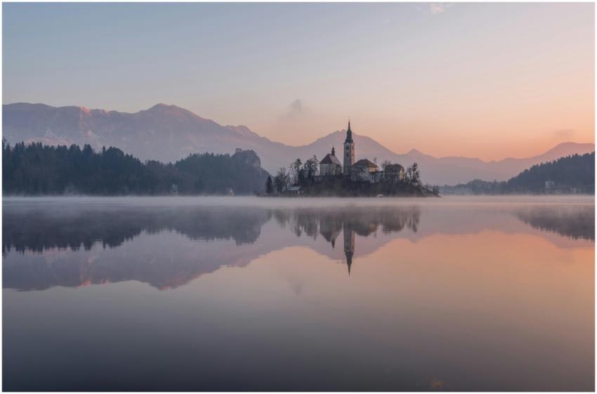 Tranquil morning view of Lake Bled with misty refl