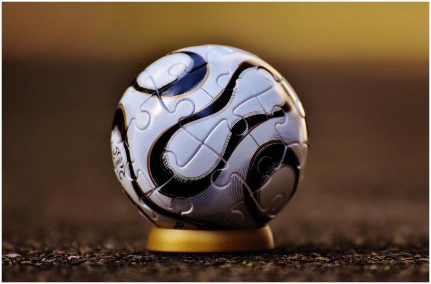 Macro shot of a soccer-themed puzzle ball on a sta