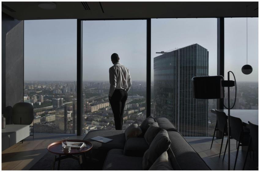 Man in a modern apartment with a panoramic view of