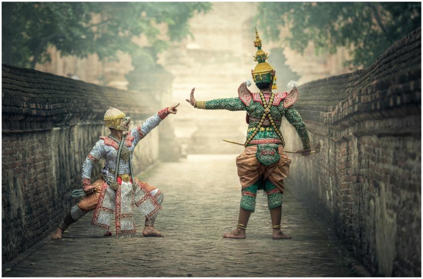 Two performers in vibrant traditional costumes per
