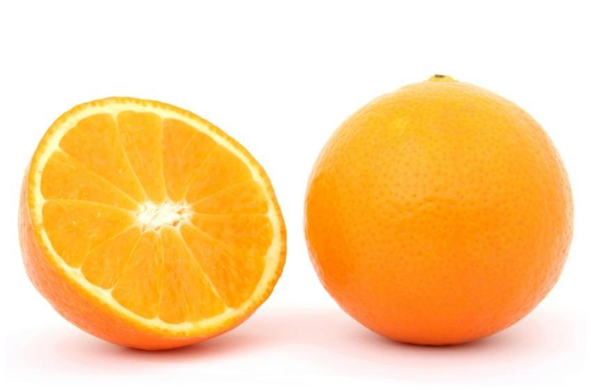 Close-up of a whole orange and a sliced half on wh