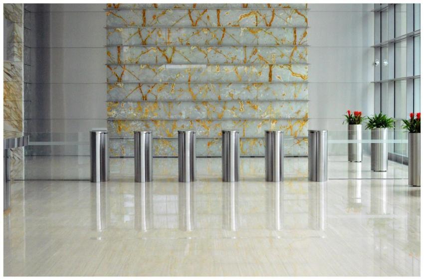 A sleek corporate lobby featuring marble walls, me