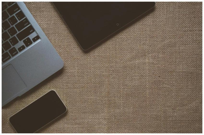 Flat lay image of laptop, tablet, and smartphone o