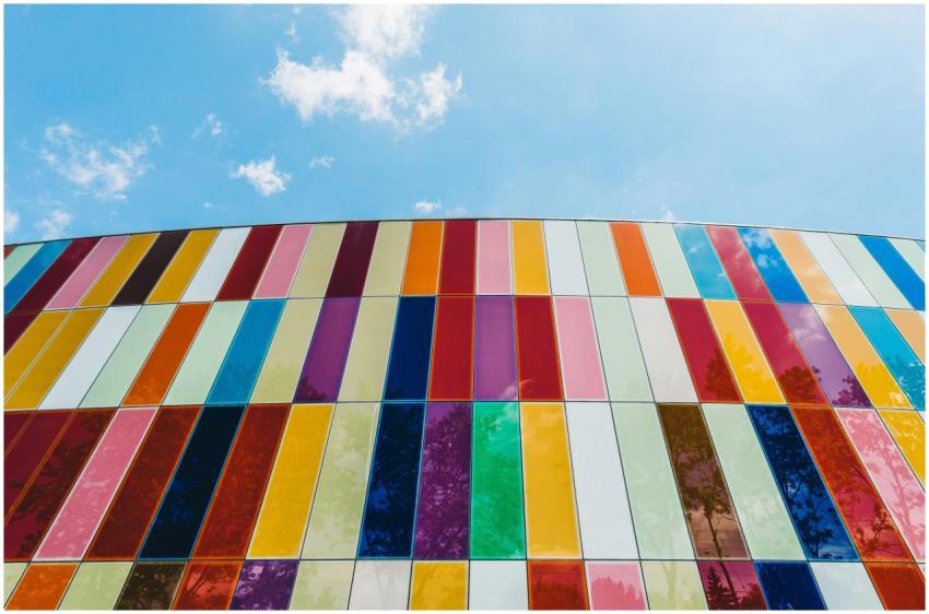 A colorful glass facade with vertical stripes unde