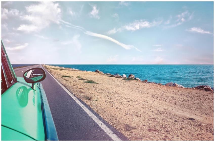 A scenic road trip in a vintage car along a stunni